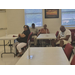  People sit at tables in a room. 