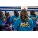  The backs of volunteers in their Back to School shirts. 