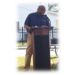  A man speaking at a podium. 