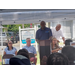  People sitting and listening to a man speak at a podium. 