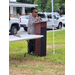  A woman in glasses speaks behind a podium. 