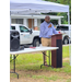  A man speaks behind a podium. 