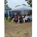  A group of people sit under a tent. 